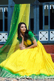 Richly textured yellow Organza Anarkali with authentic Bandhani detailing.