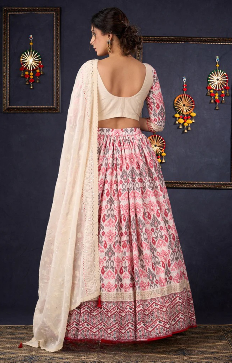 Elegant Off-White & Red Ikat Print Lehenga With Matching Blouse & Dupatta.