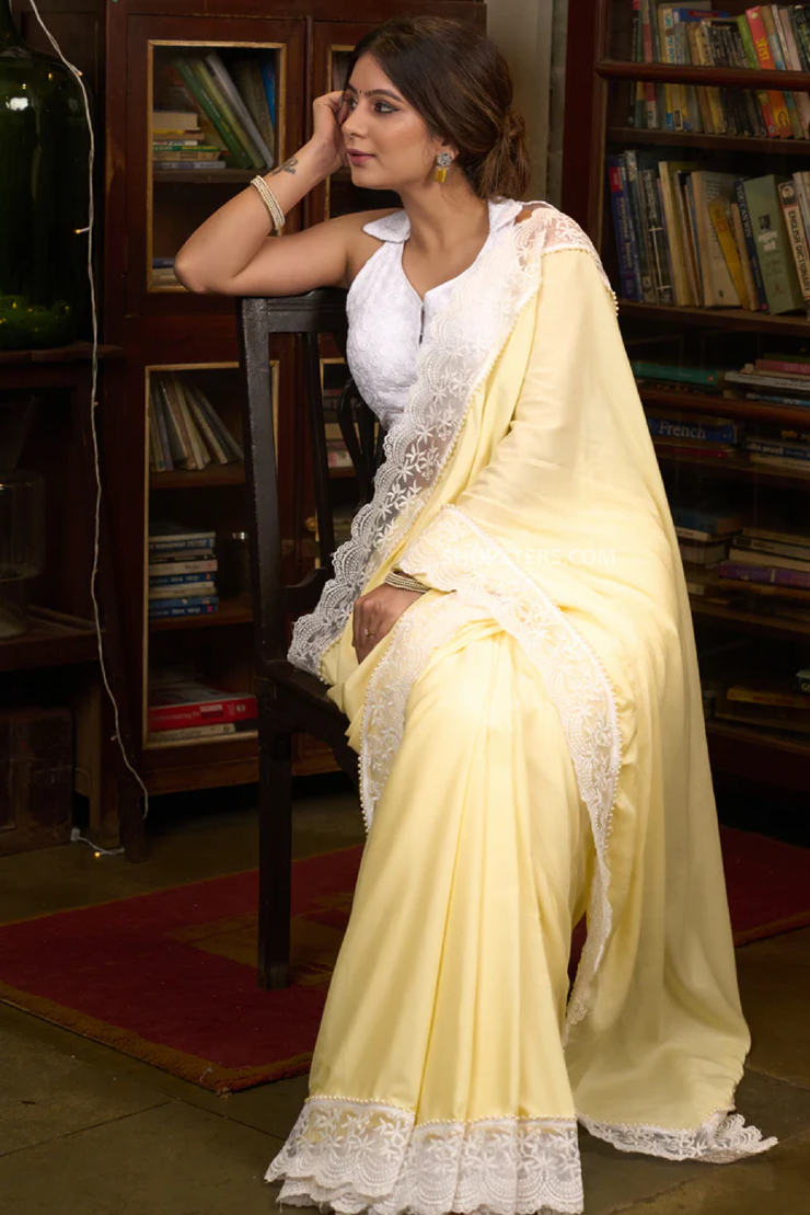 Gracious pastel yellow modal cotton saree highlighted with beautiful laces