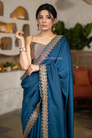 Lustrous Teal Muslin Saree Highlighted With Beautiful Matching Lace