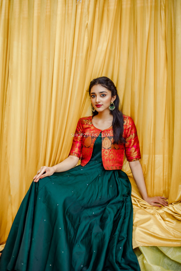 Discover the charm of Indian wear for women with our green silk dress and red brocade jacket ensemble.